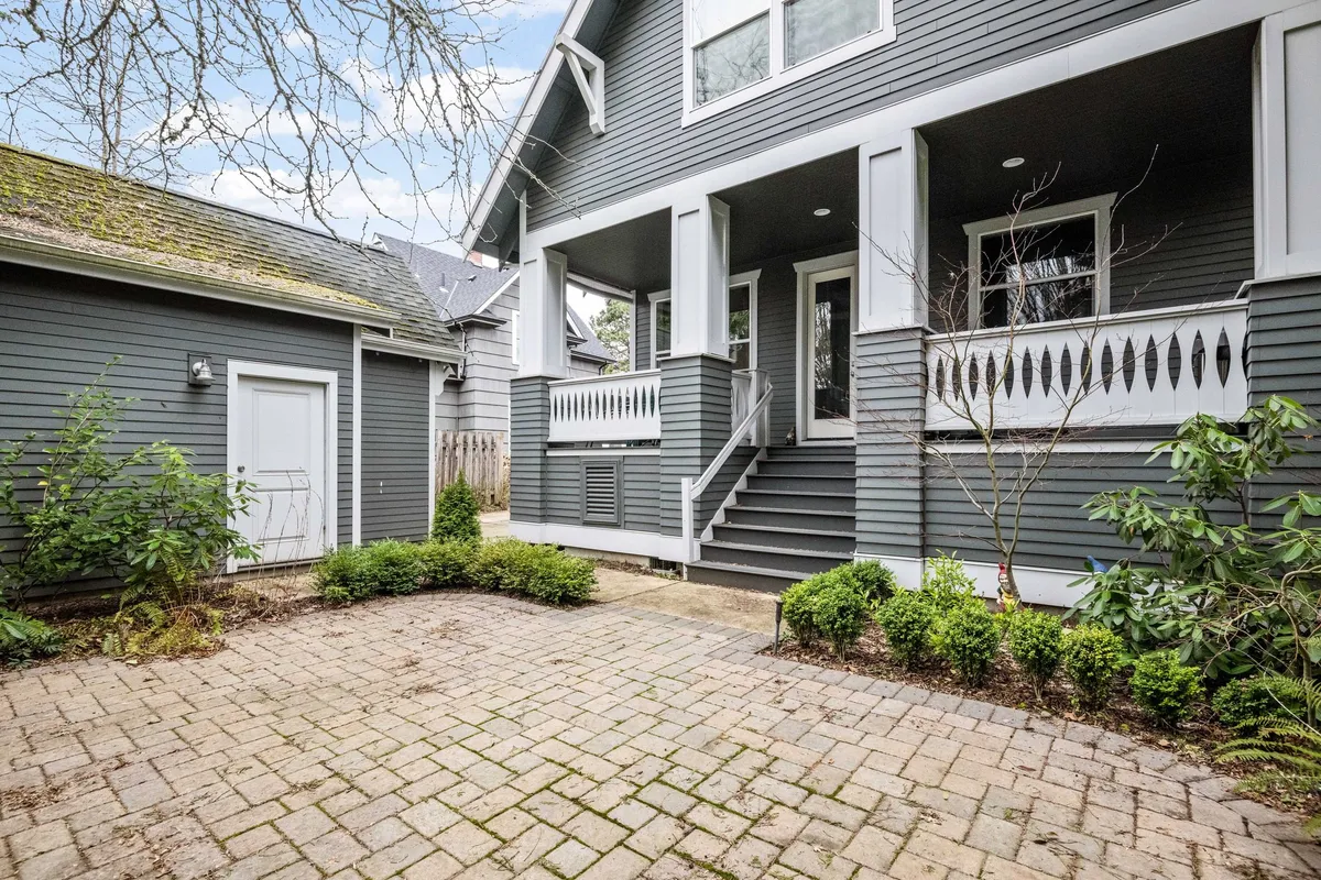 A close-up of landscaped front steps, a brick pathway, and a vibrant garden, this image hints at the peaceful, walkable neighborhood and the ease of stepping out for park visits or strolls. The inviting front porch and garden setting reinforce the section's emphasis on outdoor fun and community exploration.