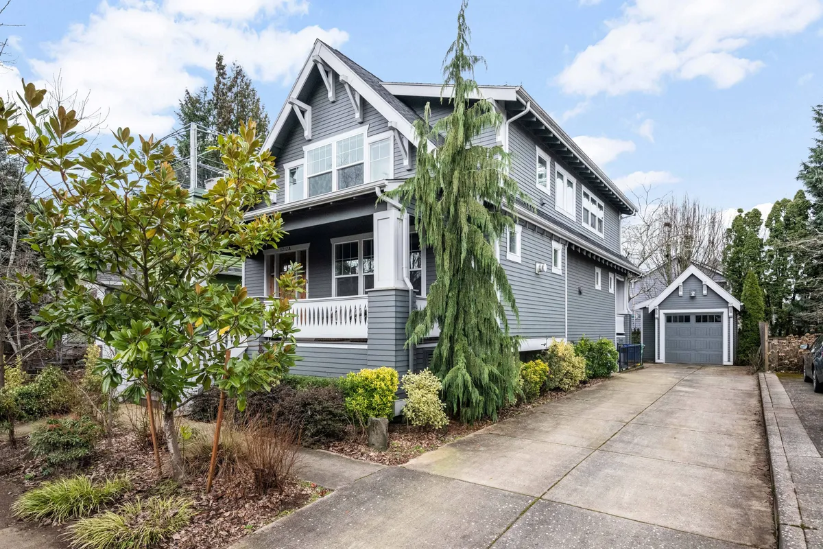 The exterior of the home features beautiful, intricate architecture surrounded by a well-maintained garden. The inviting porch and driveway hint at a welcoming space perfect for coming and going between family adventures. The scene suggests relaxation and connection, with ample outdoor space for enjoying nature or hosting family activities.